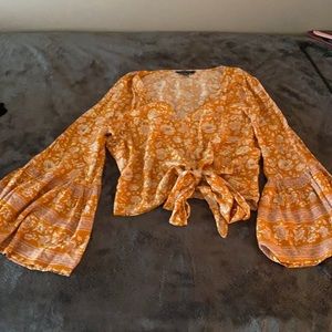 Golden yellow bohemian top. Bell sleeves. Ties at waist.
